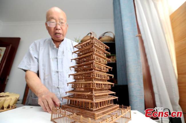 Στην φωτογραφία ο Τζινγκ Τζινσάν - ένας ηλικιωμένος άνδρας που συνεχίζει ακόμα σήμερα να δημιουργεί μικρά αριστουργήματα με την τέχνη του μπαμπού – δείχνει το μοντέλο του Πύργου της Τσανγκ’αν στο Σι’αν, της επαρχίας Σαανσί της βορειοδυτικής Κίνας, στις 4 Αυγούστου 2021. (Φωτογραφία: China News Service)